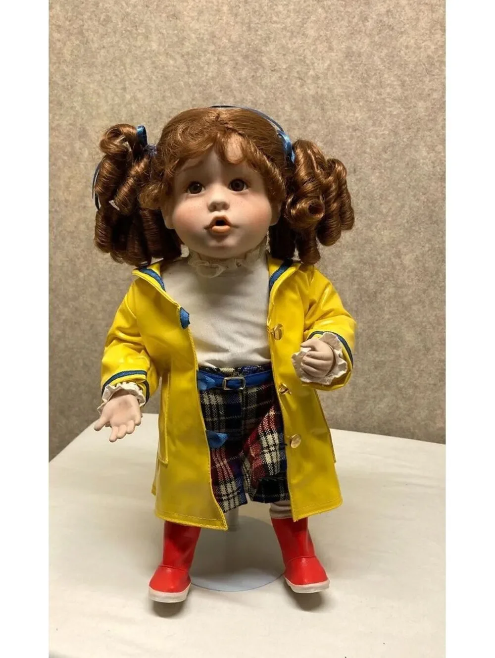 The Danbury Mint 'Kelly' Porcelain Doll with Blue Umbrella and Yellow Raincoat